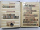 an open book with stamps on it on a table