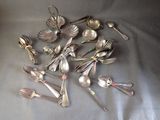 a lot of silver spoons and spoon spoons on the table