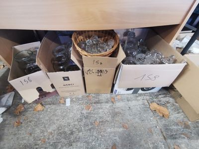 de nombreuses bouteilles d'eau rangées dans des cartons posés par terre