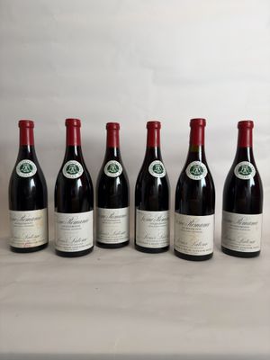 six bottles of wine are lined up on a table