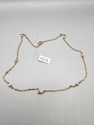 a gold chain bracelet with pearls and a tag on it