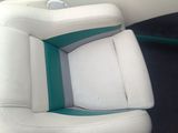 a picture of a seat in a boat that is white and green