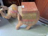 an elephant statue with a box on its back