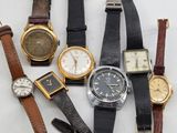 a lot of watches that are sitting on a table