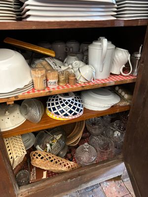 a cabinet full of dishes and cups and plates