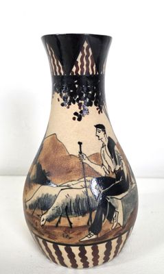 a vase with a picture of a man riding a horse