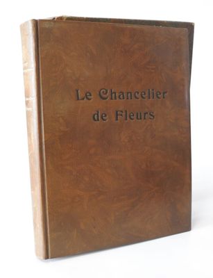 brown leather book with black lettering on it sitting on a white surface