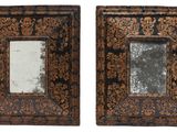 pair of ornate wooden frames with a mirror in the middle