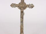 brass crucift with a cross on top of it on a white background