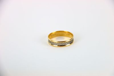 a close up of a gold ring on a white surface