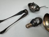 three spoons and two spoons sitting on a table