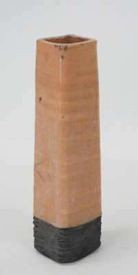 a brown vase with a black stripe on it