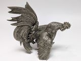 silver metal rooster figurine on a white background
