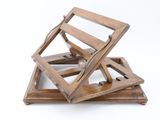 three wooden trays stacked on top of each other on a white surface