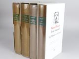 three books are stacked on top of each other on a white surface