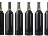 six bottles of wine are lined up in a row
