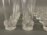 four clear glass vases sitting on a table