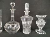 three glass vases and a glass candle holder on a black background