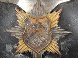 a close up of a metal armor with a gold eagle on it