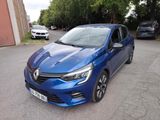 La voiture bleue est garée sur le parking, près des arbres.