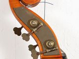 a close up of a violin on a white surface