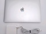 a white apple laptop with a charger and a charger