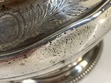 a silver plate with a flower design on it