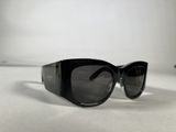 black cat eye sunglasses on a white surface with a white background