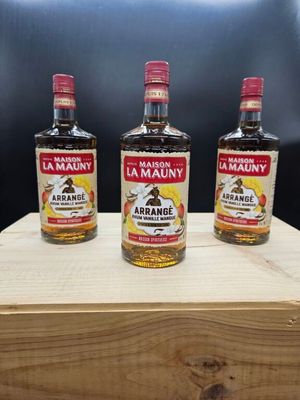 trois bouteilles d'alcool posées sur une caisse en bois