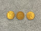 three gold sovereigns, one of which is a sovereign and one of which is a sovereign