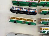 a lot of toy buses that are sitting on a table