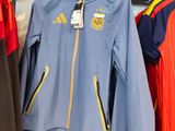 a blue jacket hanging on a rack in a store