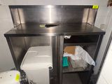 an image of a kitchen with a sink and a trash can