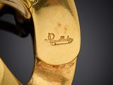 an image of a close up of a gold watch on a black surface