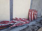 a pile of baseball bats leaning against a wall