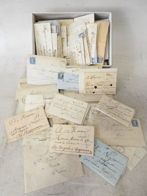 several old letters and envelopes are in a box on a table