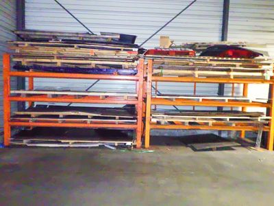 a garage with a lot of shelves and a rack of skateboards