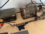 a table with a phone, a radio, and other items on it