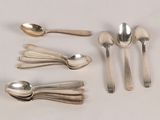 five spoons and two spoons sitting on a table