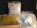 two bags of pillows and a pillow on a table