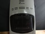 a white and black heater sitting on a wooden table