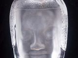 a glass vase with a face inside of it