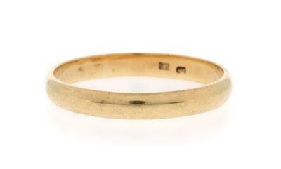 a close up of a gold ring on a white background