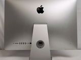 a silver apple computer sitting on top of a white table