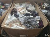 a cardboard box full of clothes on the floor