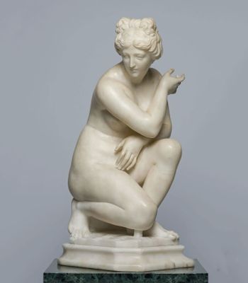 marble statue of a woman kneeling on a marble base