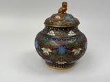 a vase with a lid that has a bird on it