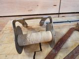 a spool and a pair of scissors sitting on a table