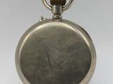 an antique silver pocket watch on a stand on a white background