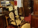 many chairs and a cabinet in a room with a red carpet